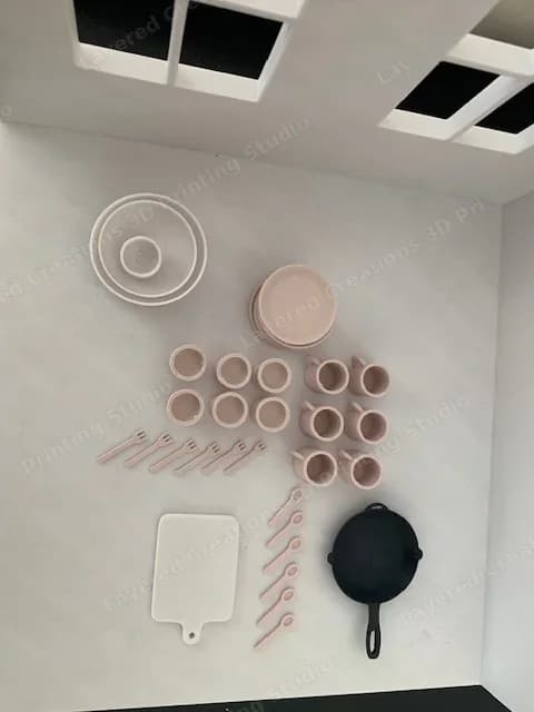 Miniature 3D printed kitchen essentials — cups, plates, bowls, cutlery and a cast iron style pan